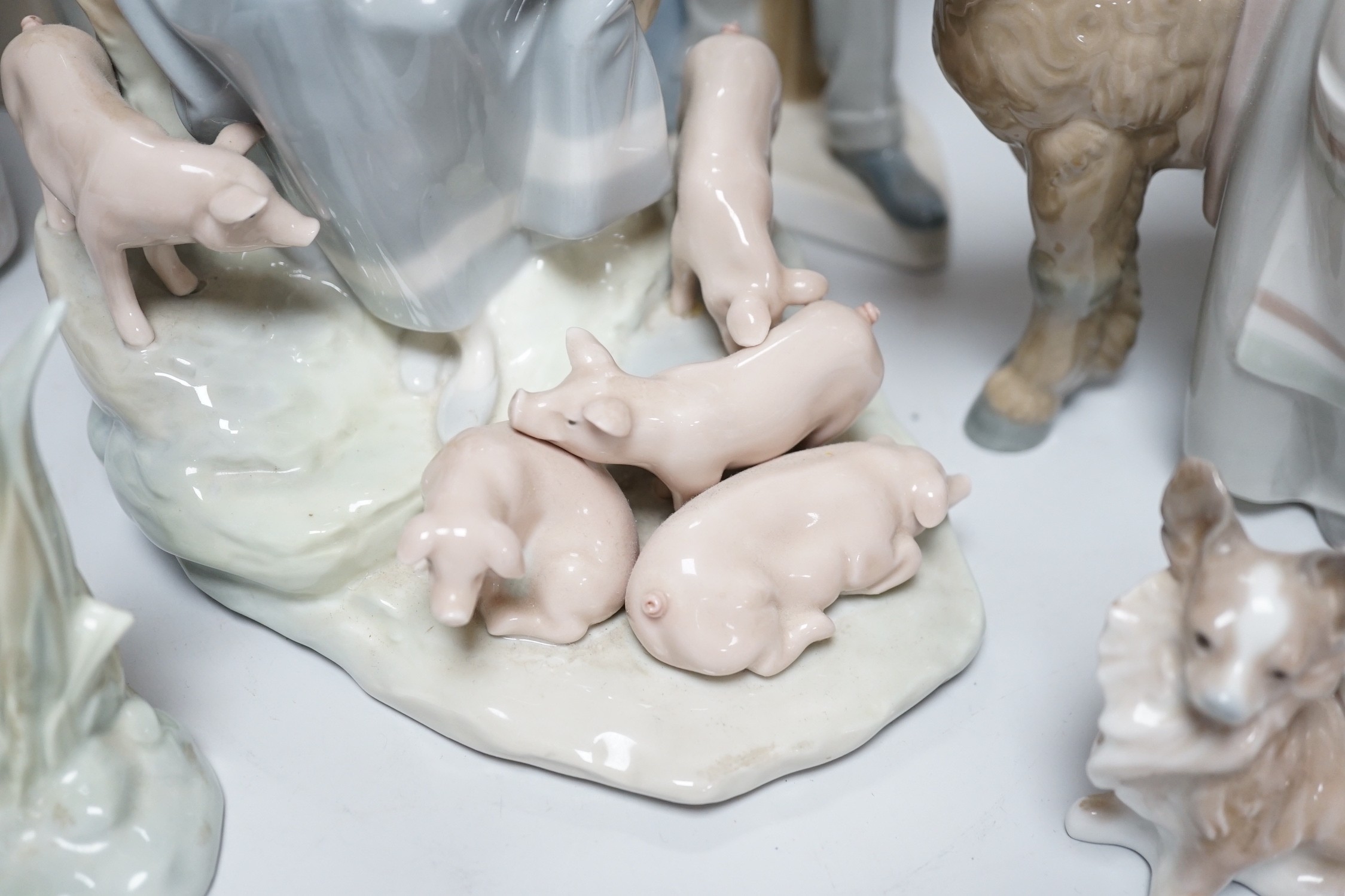A collection of nine Lladro porcelain figures, tallest 36cm